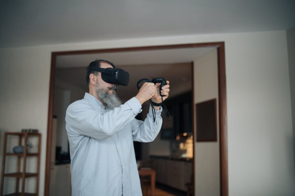 Elderly man engaging with virtual reality technology indoors with a cheerful expression.
